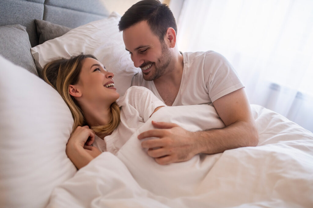 A,Joyful,Couple,Shares,A,Tender,Moment,While,Lounging,Under